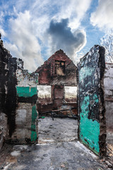 burned house,Image of a burned abandoned house in an urban setting with overcast sky.