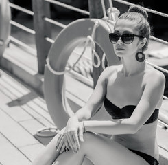 Fototapeta na wymiar young curly woman relaxing near life-saving buoy