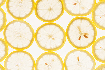 Slices of lemon on a white background. Pattern. Macro. Fruit background.