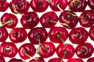 Cherry background. Pattern of fresh cherries on white. View from above. Macro. Food background.