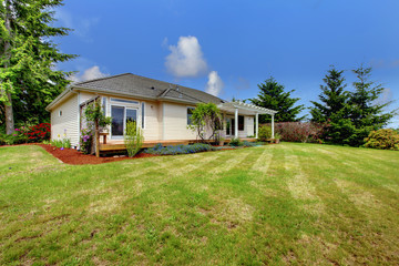 Fototapeta na wymiar Small American home. large grass filled lawn
