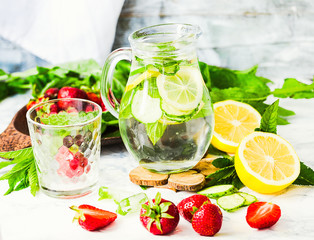 water-detox with lemon, strawberries and mint on light backgroun