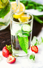 Water with strawberries, lemon, ice, mint. Detox.