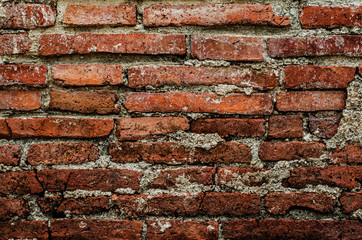 Background of Old damaged brick wall with plaster from temple wa