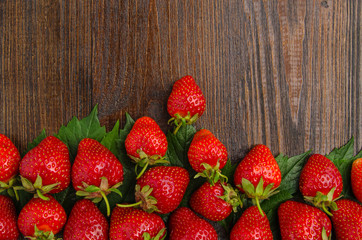Many tasty strawberries on old wooden background