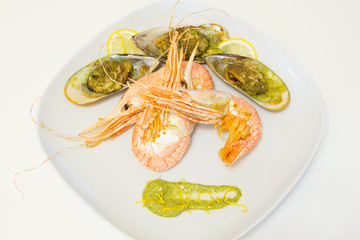 Large shrimps and mussels on a white plate