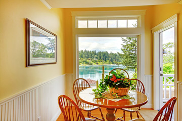 Small dining area with round old table and chairs.
