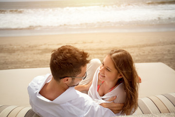 laughing couple lying on sunbed