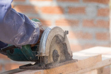 Carpenter using circular saw in loggers