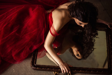 portrait of sensual woman in a long gorgeous red dress
