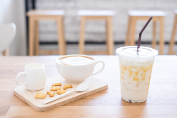 Cup of coffee and biscuit on wooden table