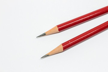 Two red pencils on white background