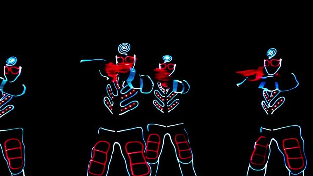 4 people dancing in costumes of LEDs 