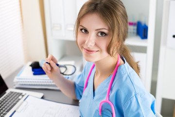 Portrait of female medicine doctor working at her office