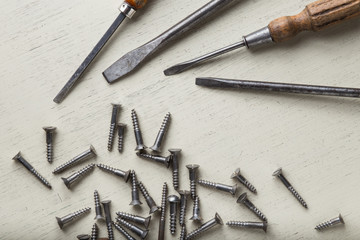 Accessory, assorted tools set on wooden light background. Construction assortment instruments for repairman, carpenter, builder. Copy space for text. Top view. 
