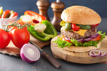 homemade cheese burger with peppers tomato onion