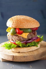 homemade cheese burger with peppers tomato onion