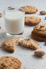 Cookies pile with chocolate chip and almond on light textile background. Delicious morning snacks for breakfast, brunch and lunch. Appetizing, healthy and fast food
