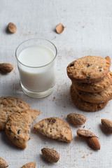 Cookies pile with chocolate chip and almond on light textile background. Delicious morning snacks for breakfast, brunch and lunch. Appetizing, healthy and fast food
