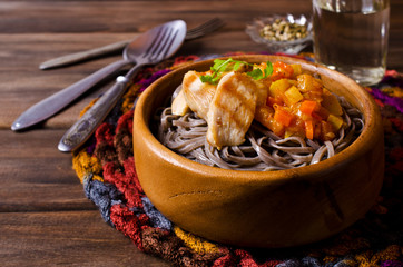 Dark pasta with vegetables and chicken.