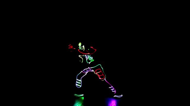 4 people dancing in costumes of LEDs 