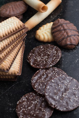 Cookies assorted on black background. Delicious morning snacks for breakfast, brunch and lunch. Appetizing, sweet and fast food.
