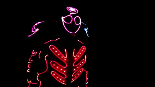 4 people dancing in costumes of LEDs 