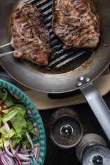 Steak cooking on grille pan. Fresh, delicious, spicy meat on a kitchen with copy space closeup