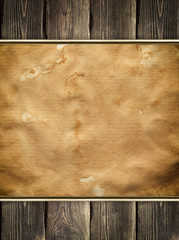 Old stained paper sheet on wooden background