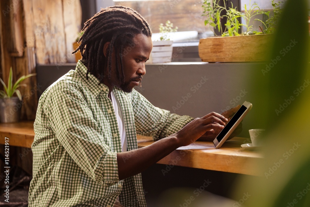 Poster man using a tablet sitting