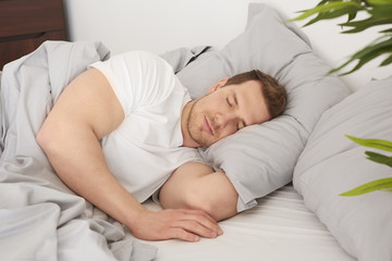 Obraz na płótnie Canvas Man sleeping in the comfortable bed.