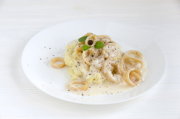 calamary rings potato puree sauce white plate