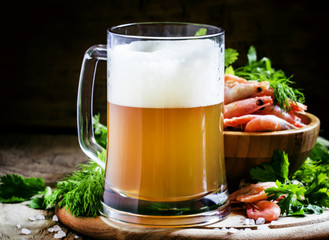 Beer and shrimp, vintage wooden background, selective focus