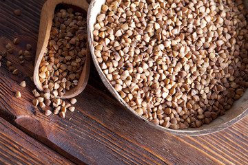 Buckwheat in bowl on wooden table