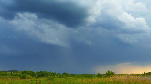 dark storm clouds are moving over countryside field, 4k
