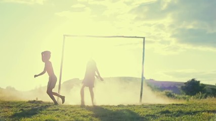 Young boy head the ball near the gate. Slow motion. - Powered by Adobe