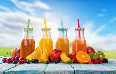 Fresh juice with fruit mix on wooden table