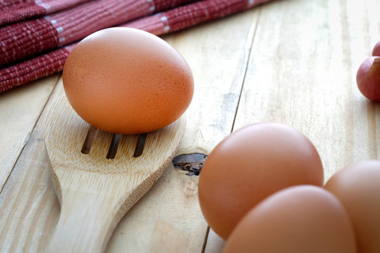 Eggs on wooden table with selective focus