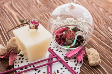 spa stuff on wooden background: candle, aroma