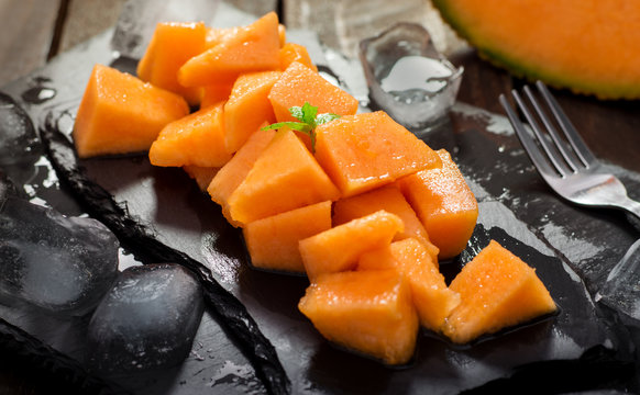 Pieces of Melon on a Granite Plate