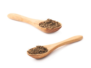 Wooden spoon full of cumin seeds