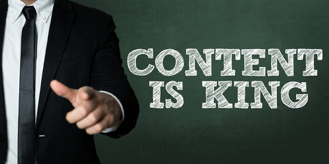Business man pointing with the text: Content is King