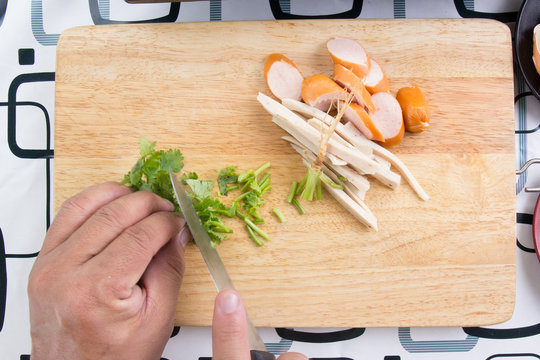 Chef chops coriander with knife