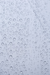 Fototapeta na wymiar Rain water drop on grey background, vertical style