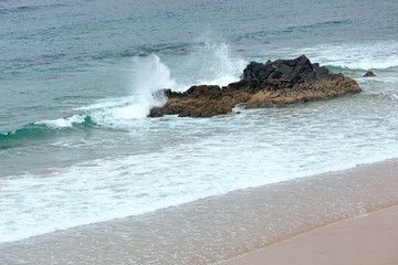 Sea surf and sandy beach.