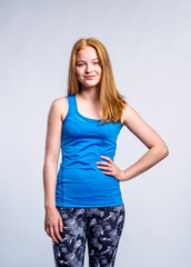 Girl in blue singlet and fitness leggings, young woman, studio s