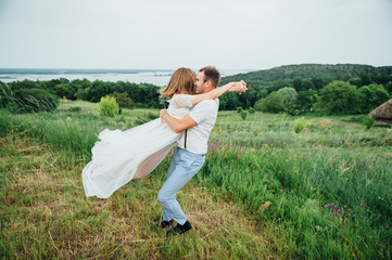 Happy Bride and groom walking on the green grass