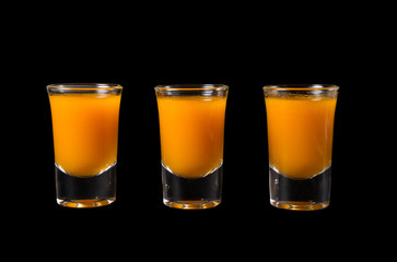 Three shots of sea buckthorn drink