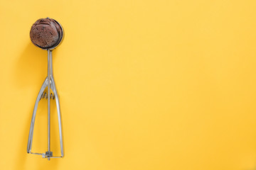 Chocolate ice cream on yellow background

