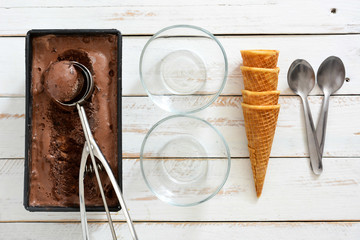Chocolate ice cream on a white wooden background

